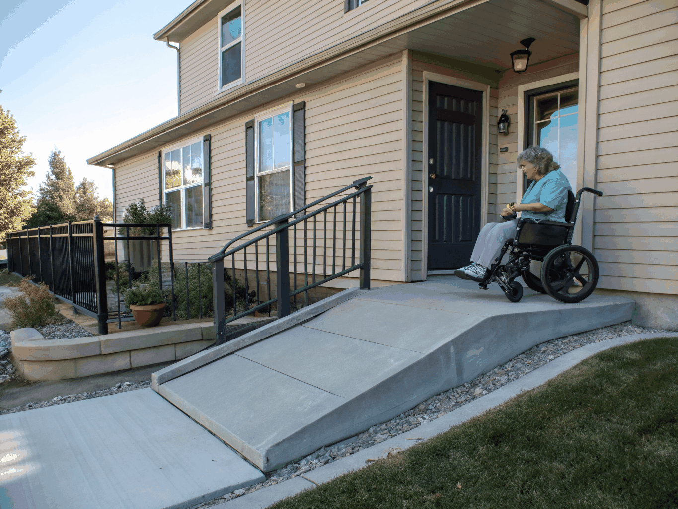Modular aluminum accessibility ramp leading to a residential front porch